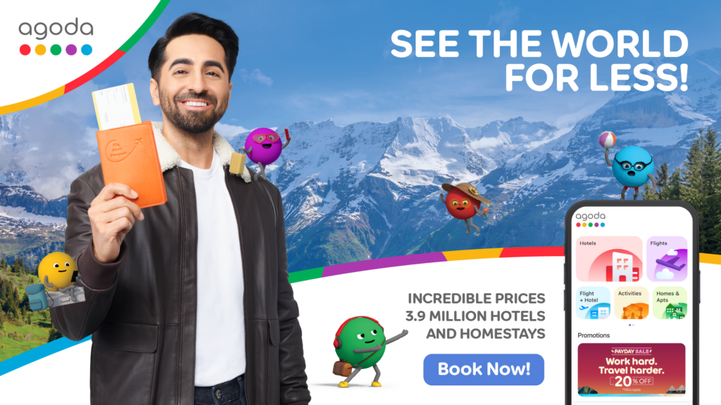 A smiling man in a brown jacket holding an orange passport holder and a ticket, standing in front of mountains. Cartoon characters representing travel services are scattered around, and an Agoda app interface is shown on the side with travel offers.